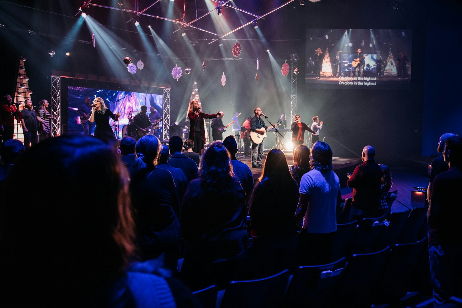 Services a group of people sitting on a stage in front of a crowd